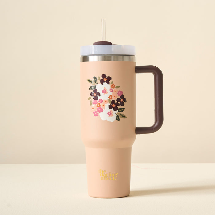The Darling Effect Buds & Bloom Mocha 40oz Take Me Everywhere Tumbler is a tall, blush tumbler with a brown handle, clear lid, and straw, featuring custom floral prints and "the calming effect" in gold at the bottom.