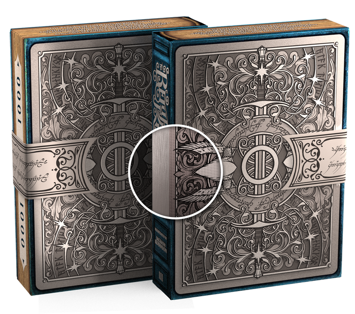 Two playing card boxes with intricate designs on a white background