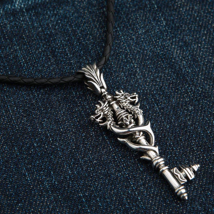 Angled view of handcrafted Viking double dragon key pendant showing three-dimensional silver detailing