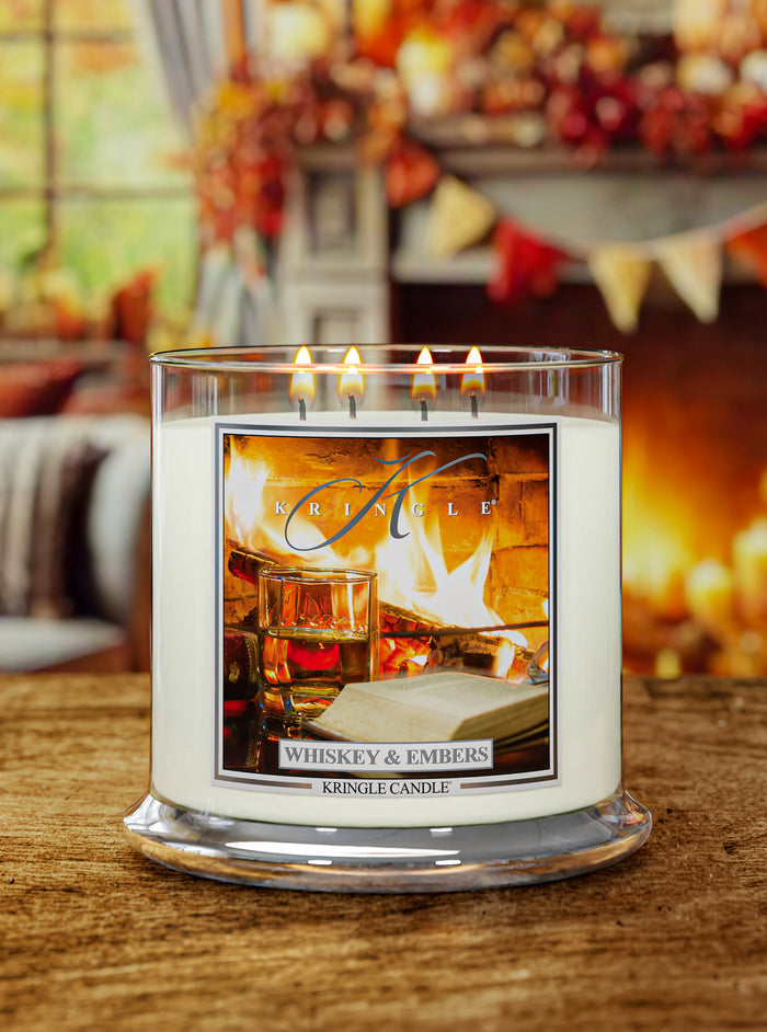 Lit Whiskey & Embers XL 4-Wick candle; label shows fireplace with a whiskey glass and an open book nearby.