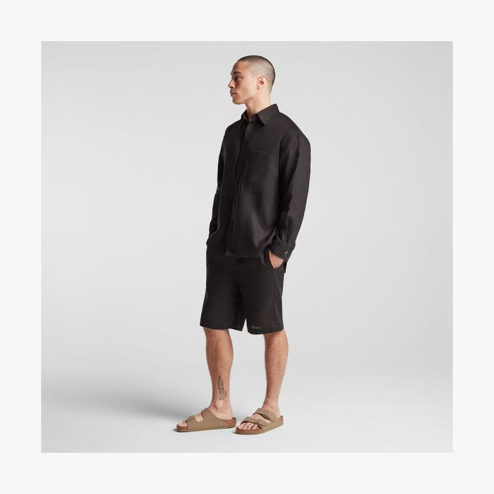 Black | Full body side view of man in Algarve Shirt in Black