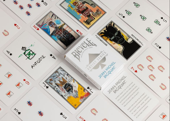 Bicycle playing cards with unique designs on a white surface