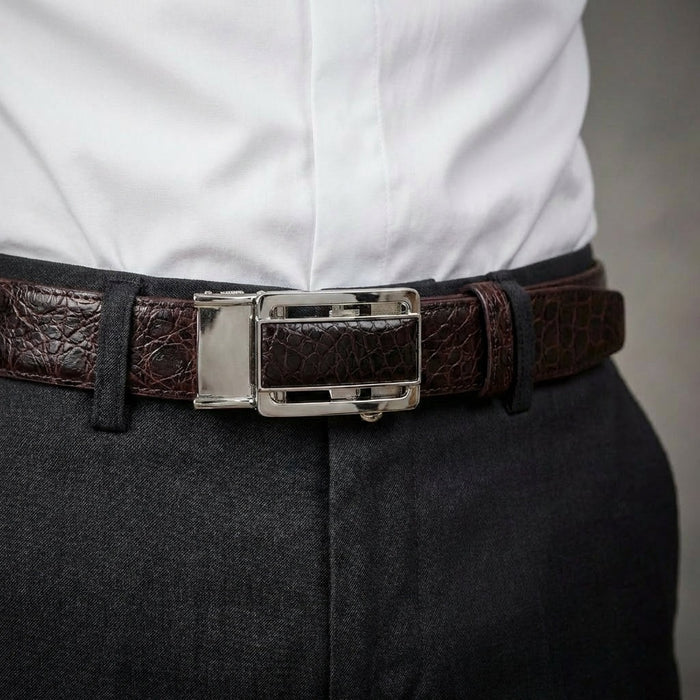 Man wearing dark brown crocodile leather dress belt with silver buckle paired with grey trousers and white shirt