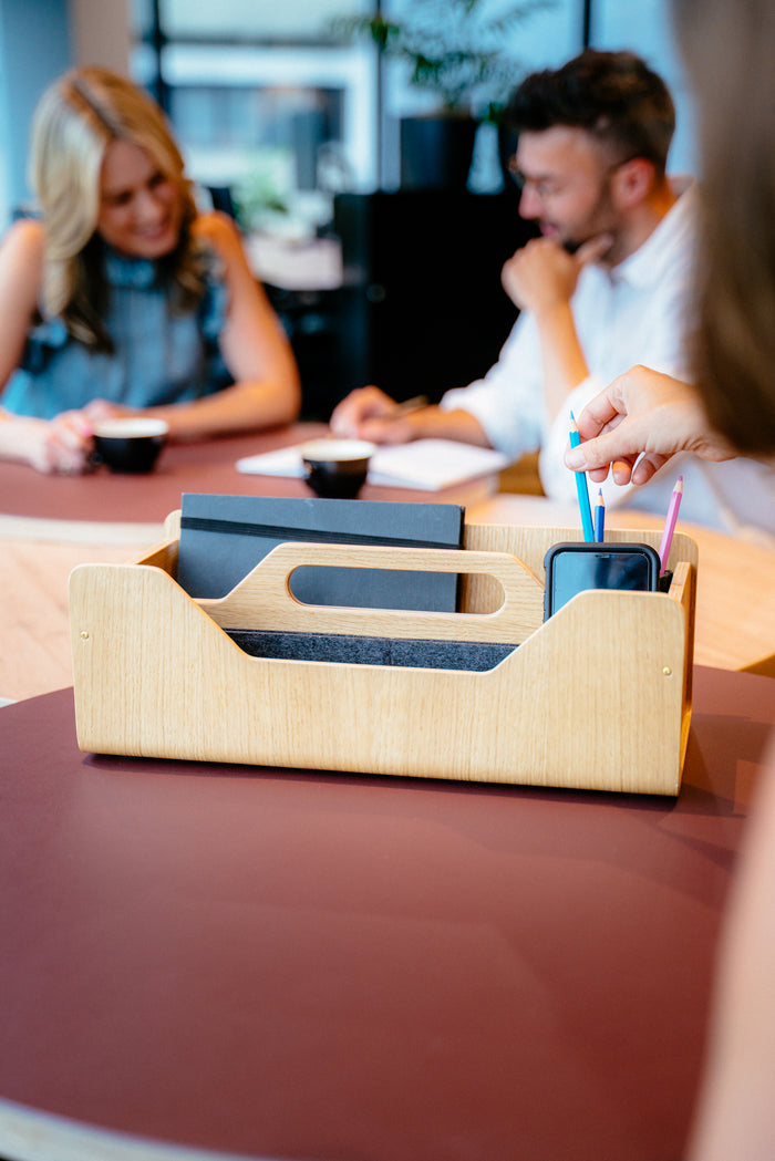 Gustav Dot desk organizer in use at a shared desk setup