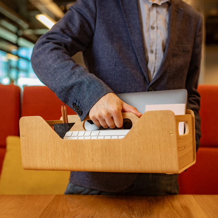 Gustav Dot XL oak wood desk organizer – lifestyle shot at a shared desk