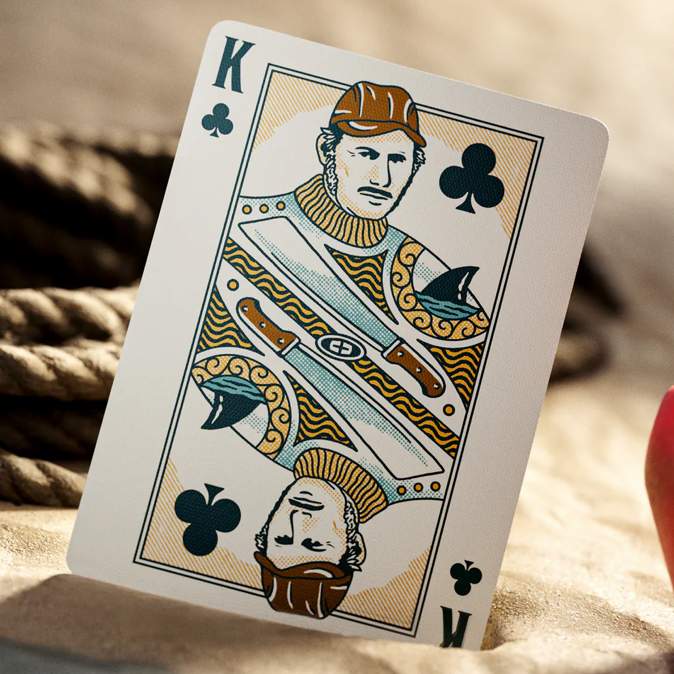 Jaws King of Clubs playing card with decorative design on a textured surface