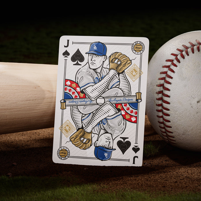 Playing card with a baseball player design, placed on a baseball and bat