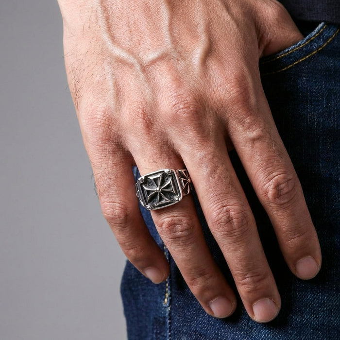 A model's hand wearing the heavy sterling silver Maltese cross ring to demonstrate its bold and impressive size.