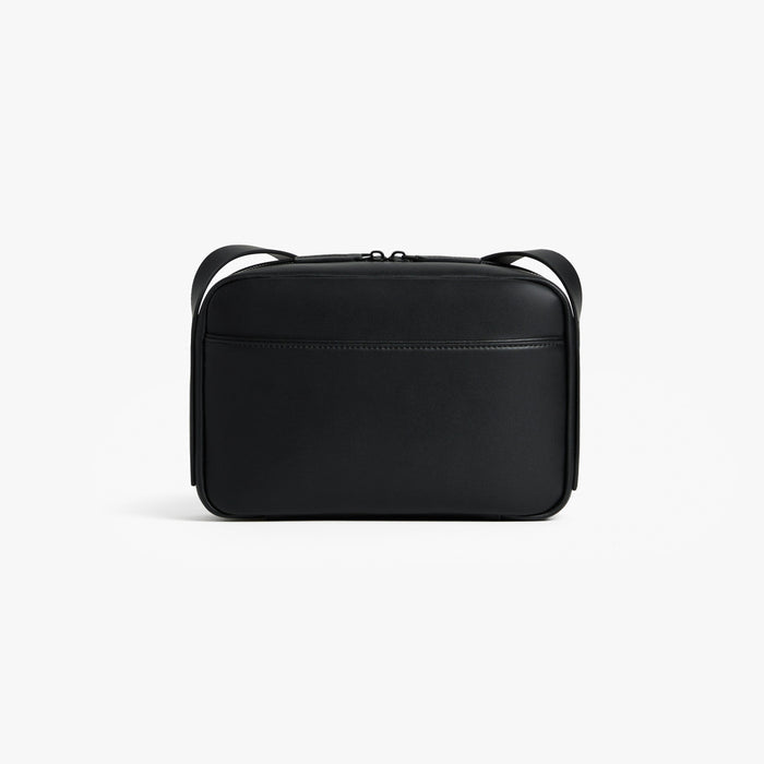 Carbon Black (Vegan Leather) | Back view of Metro Crossbody Carbon Black