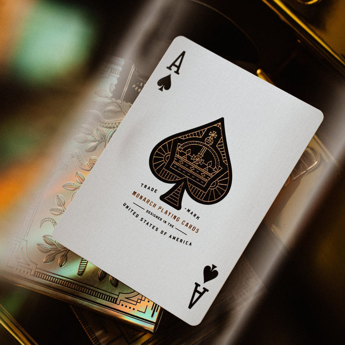 Playing card with black spade symbol on a blurred background