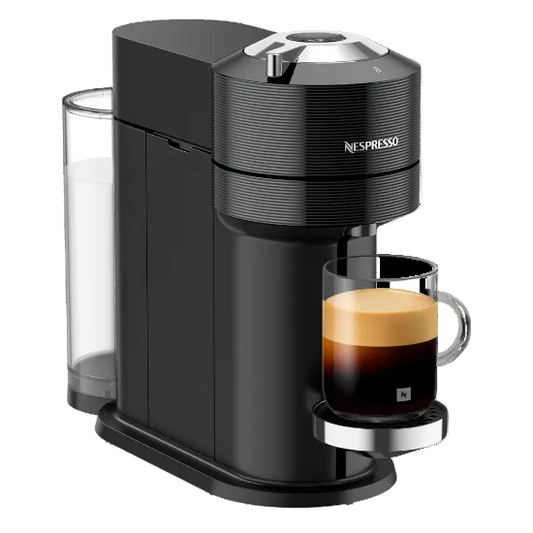 Nespresso coffee machine with a glass of espresso on a white background