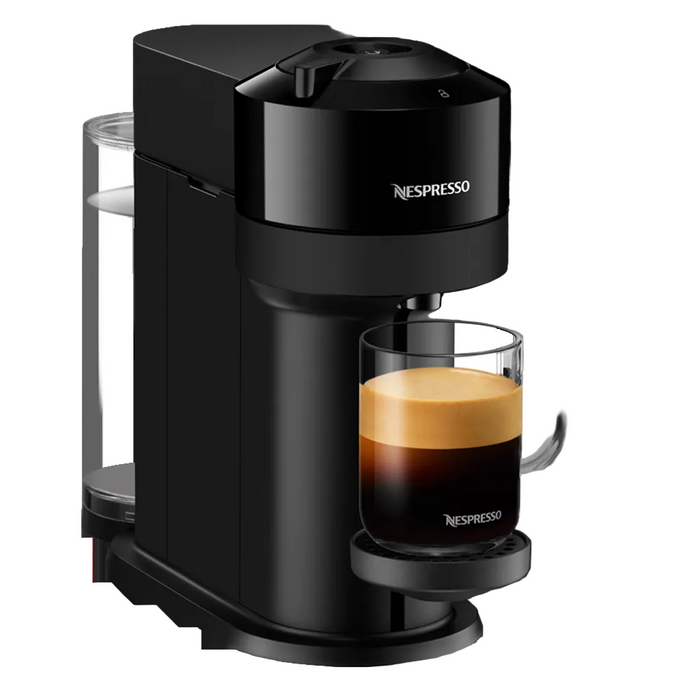 Black Nespresso coffee machine with a glass of espresso on a white background