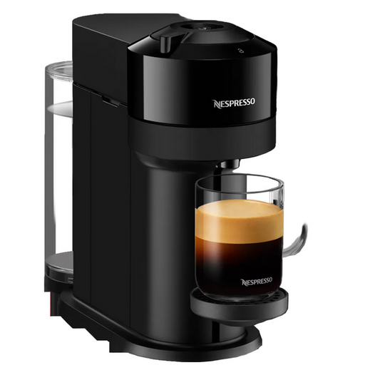 Black Nespresso coffee machine with a glass of espresso on a white background