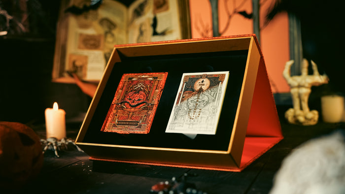 Two tarot cards in a box on a mystical table with candles and decor.