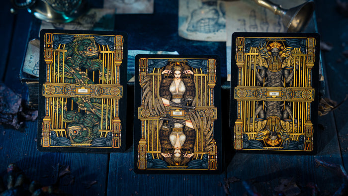Three tarot cards with ornate designs on a dark blue background