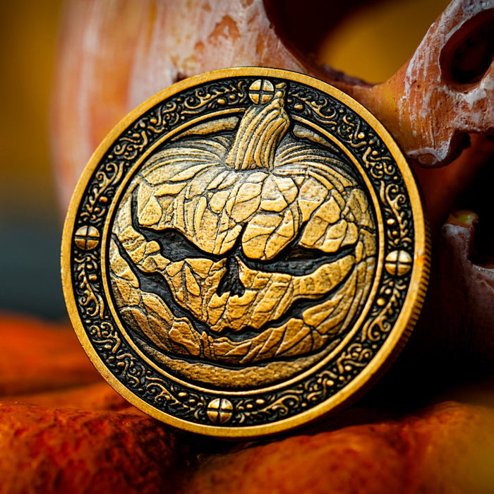 Decorative coin with pumpkin face design on a Halloween-themed background