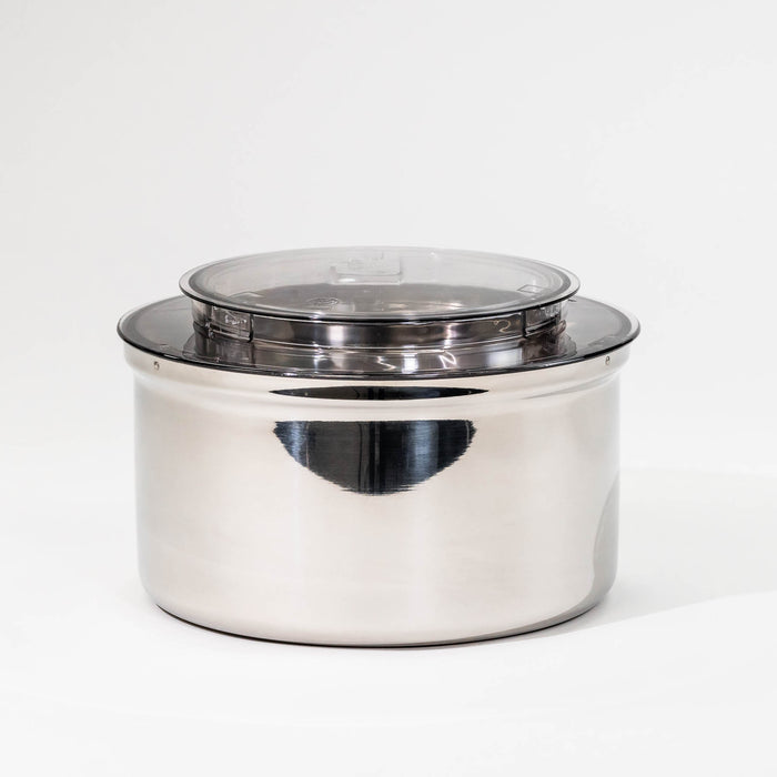 NutriMill bottom drive stainless steel bowl on a grey background