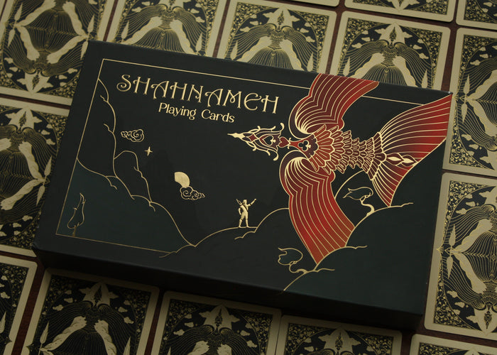 Shahnāmeh playing cards packaging with intricate design on a patterned background