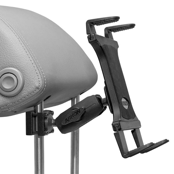The Slim-Grip® Tablet Headrest Mount securely attaches to metal rods on a gray leather headrest, providing an adjustable black holder for mobile devices or tablets and ensuring stable rear seat entertainment.