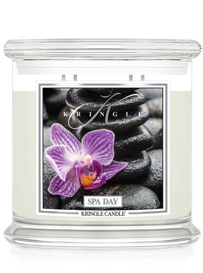 Kringle Candle Spa Day candle with purple flower and stones design on a white background
