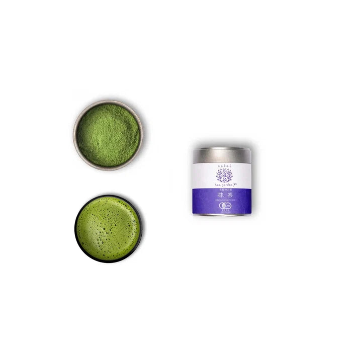 A tin container of Wazuka Tea Nakai Superior next to a bowl and a dish of matcha powder