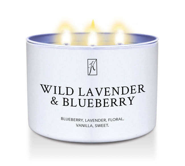 Candle in a white tin container labeled 'Wild Lavender & Blueberry' on a white background