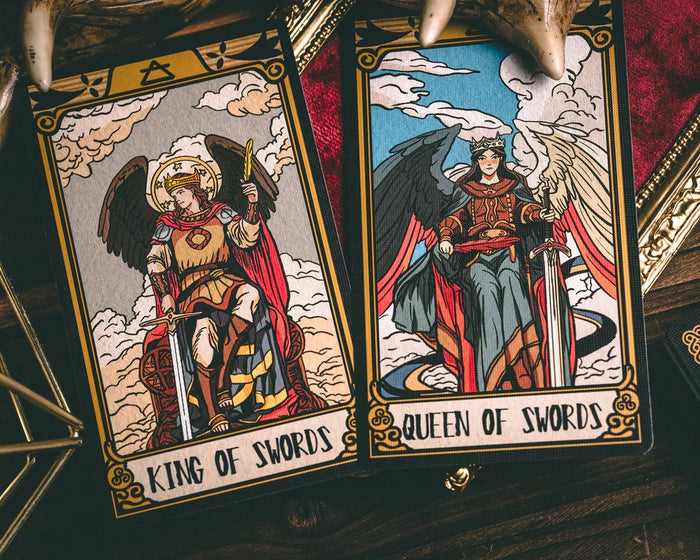 Two tarot cards titled 'King of Swords' and 'Queen of Swords' on a dark background.